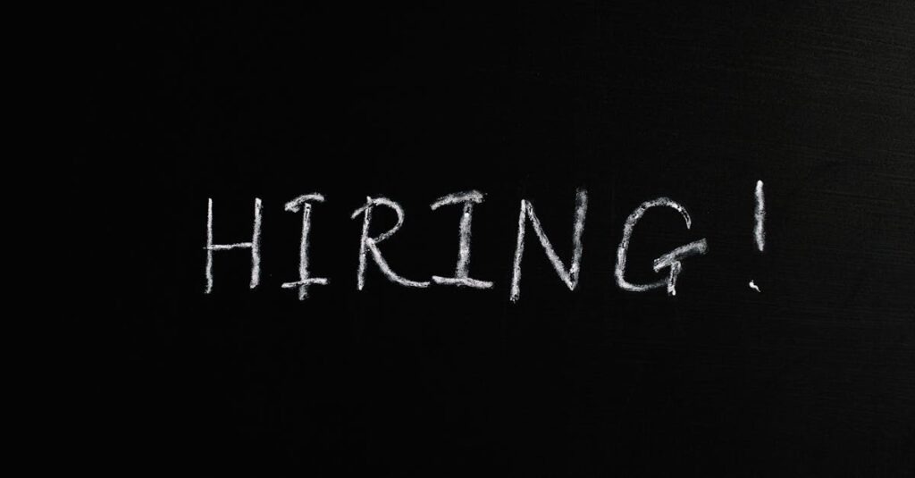 Close-up of the word 'Hiring!' written in white chalk on a blackboard, ideal for recruitment themes.